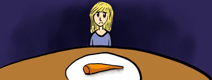 Woman staring at a carrot on the table looking like she is about to cry.