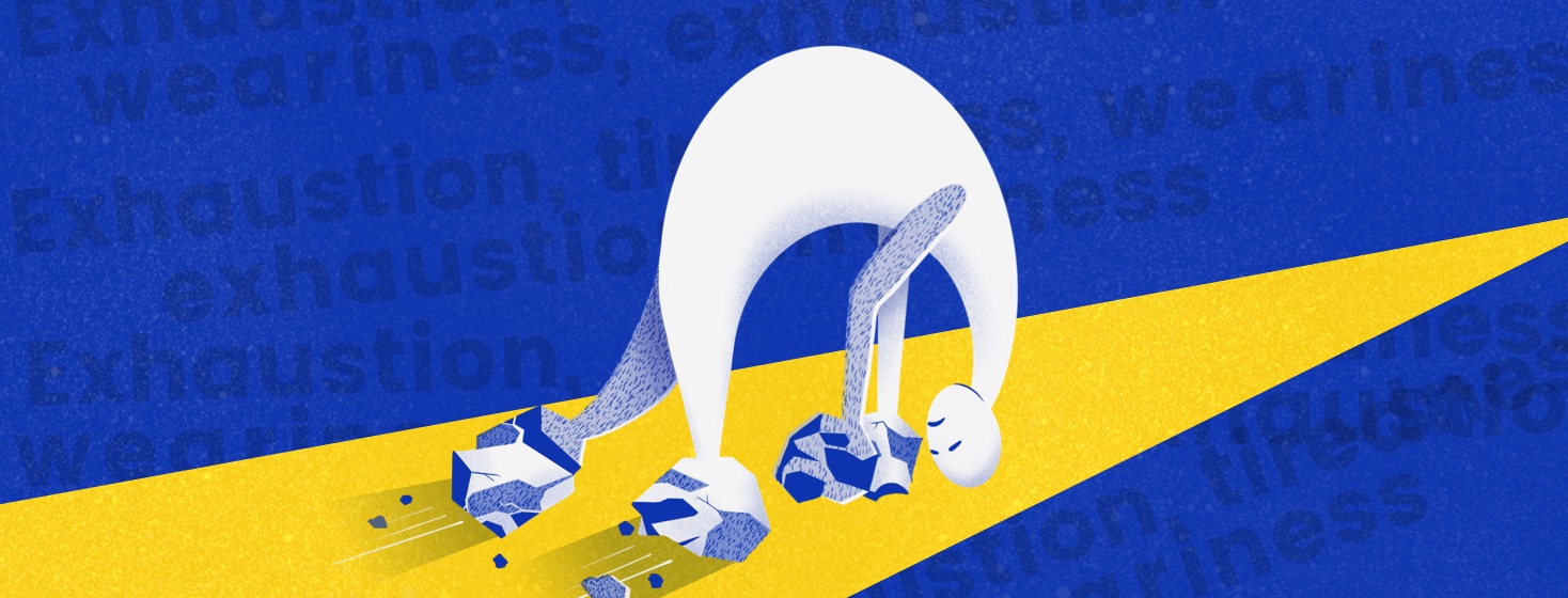 A person with rocks for hands and feet drags themself down a path, hunched over and exhausted.