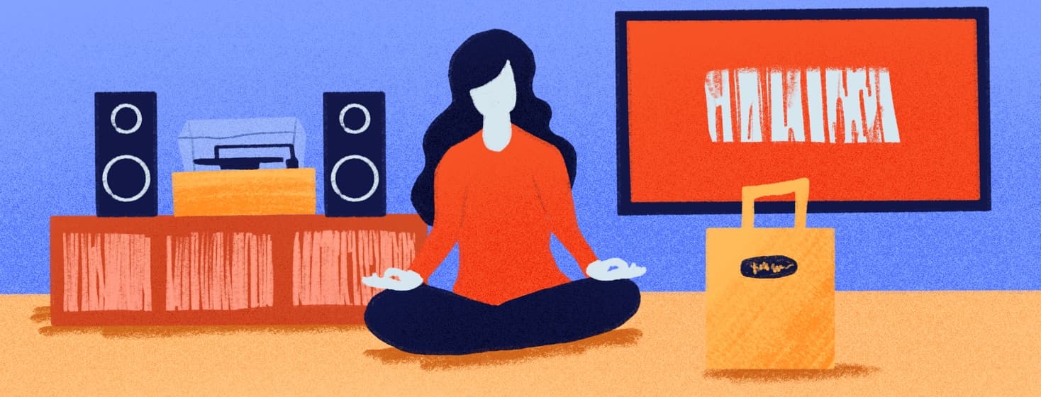 person meditating next to a record player, tv, and to go bag