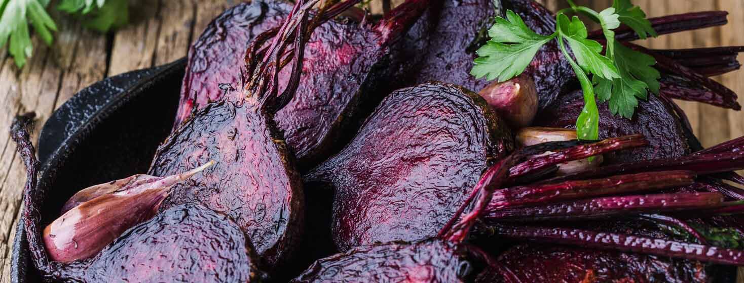 Roasted beets placed in a cast iron skillet.