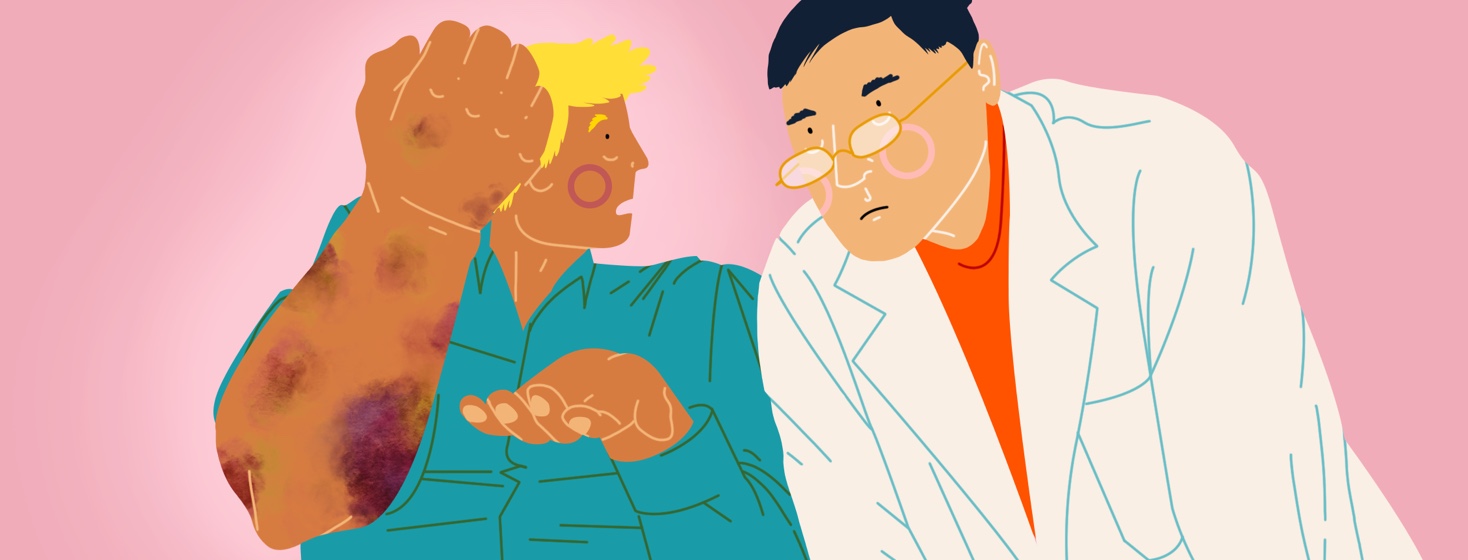 A man holds up his arm in disbelief, which is covered in bruises. A doctor leans over his shoulder to look at it.