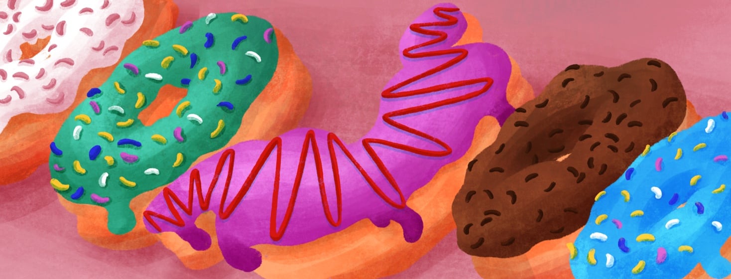 A row of brightly colored doughnuts. The center doughnut is in the shape of a stomach.