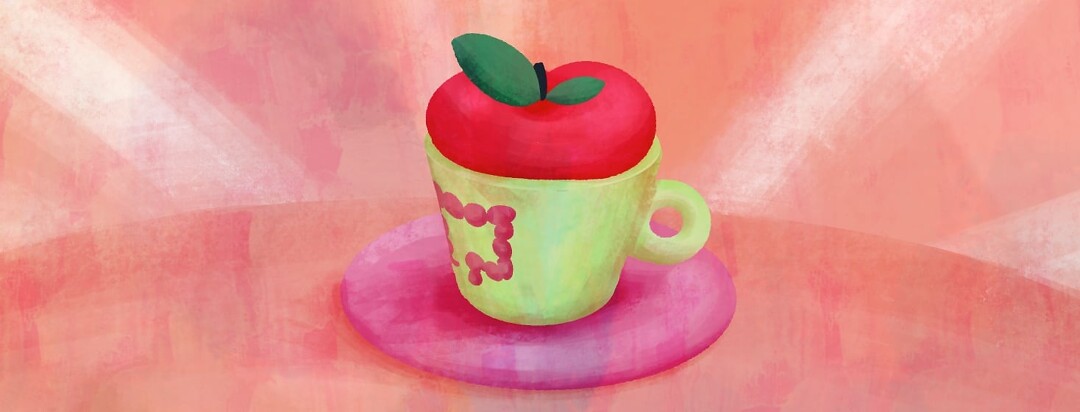A mug is sitting on a saucer. In the mug is an apple. Printed on the mug is a healthy colon.