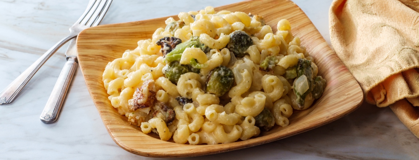 broccoli mac and cheese on a wooden plate