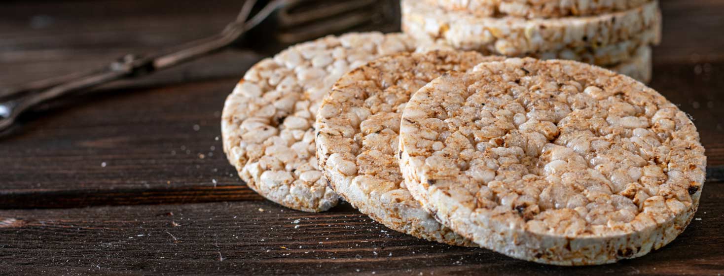 Rice cakes stacked on top of each other on a rustic wooden table