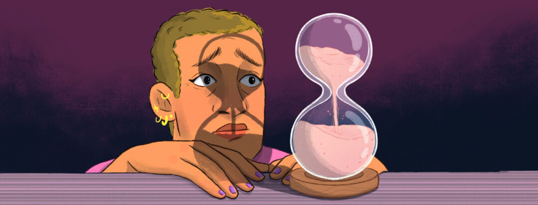 a woman stares at an hourglass unable to fathom the future